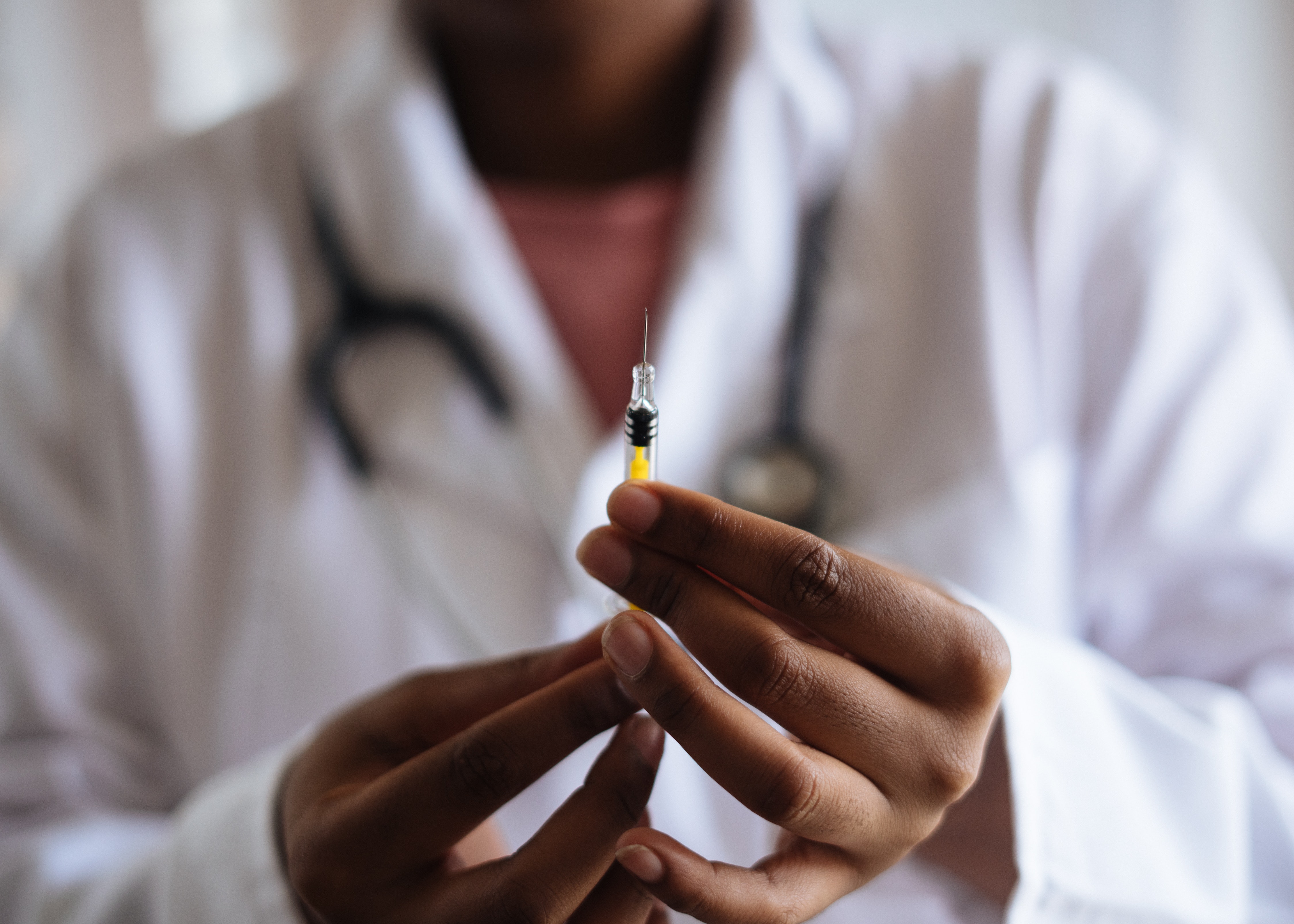 person holding a vaccine